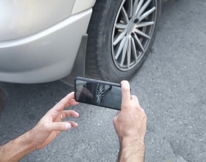 A customer viewing their advertised vehicles on a smartphone via Auto Trader